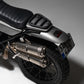 BMW R nineT Black motorcycle fender with Retro red Stop light Close-up of a motorcycle's exhaust and license plate on a gray background