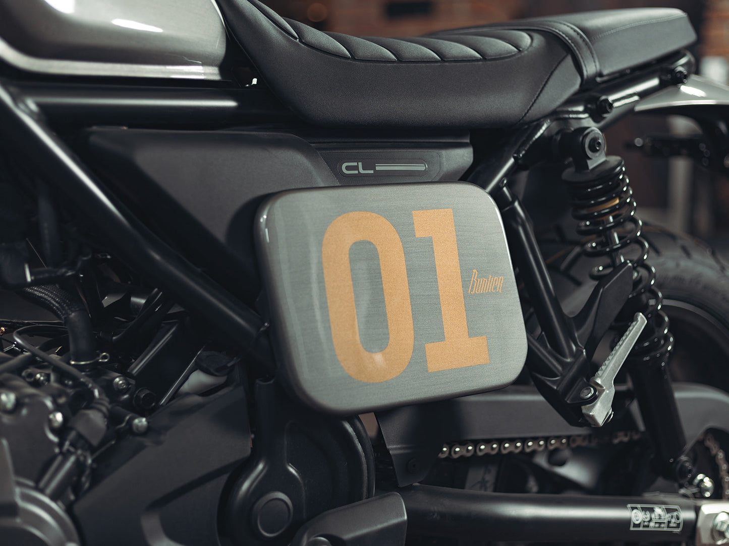 Black rectangular Honda CL250 CL500 Number Plate Side Cover with '01' printed on it, featuring a bunker logo, Glossy Metalic Grey Finish