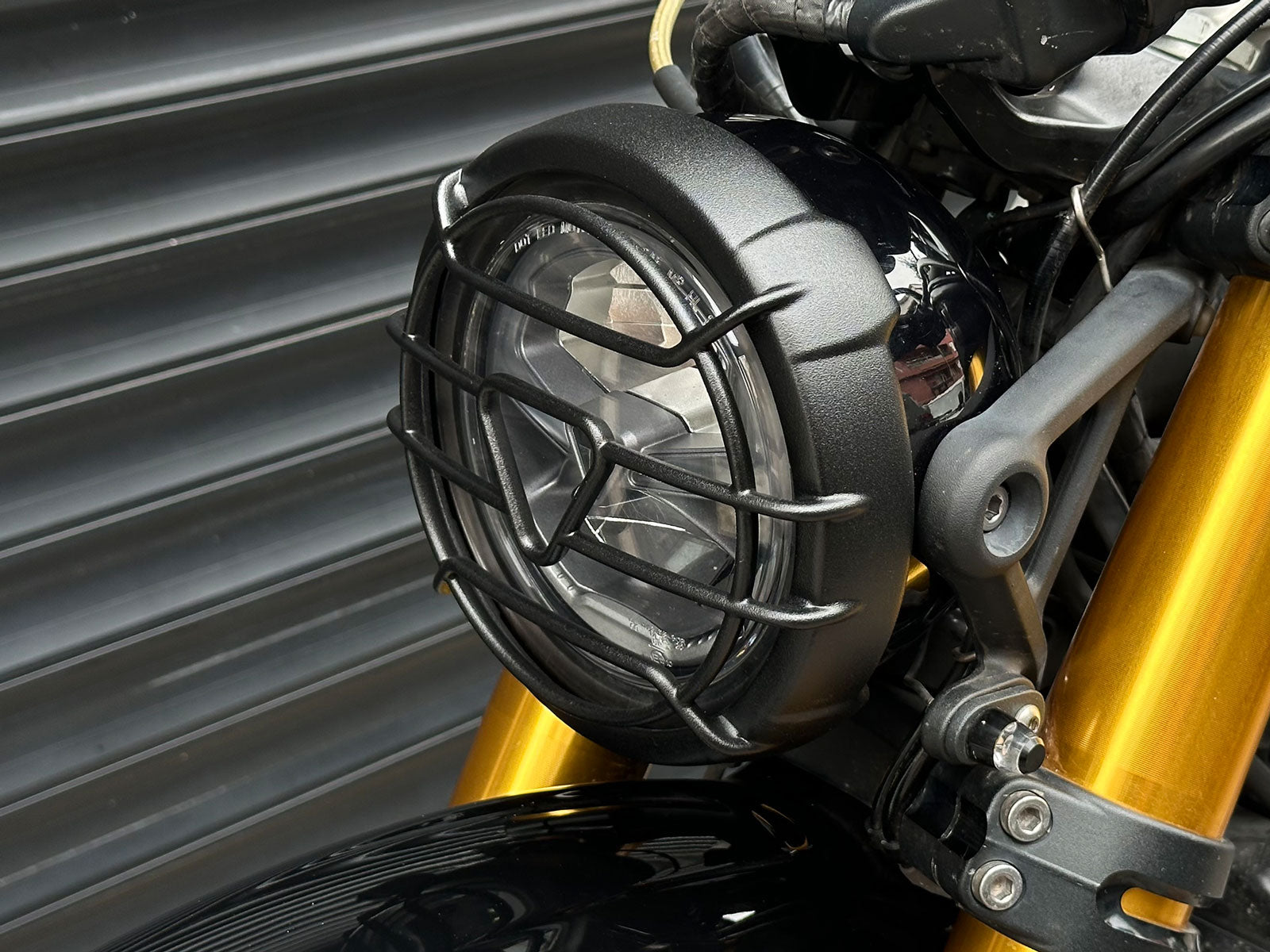 Triumph 1200 XE XC X Headlight Grill Protection Guard mounted on motorcycle Closeup
