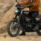 Triumph Radiator Guard Black eng'ne guard Person sitting on a motorcycle in a desert-like setting